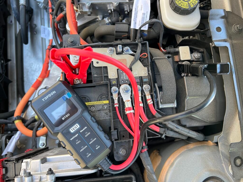 Silva's Roadside Services technician connecting a mobile charging cable to an electric vehicle in Marysville